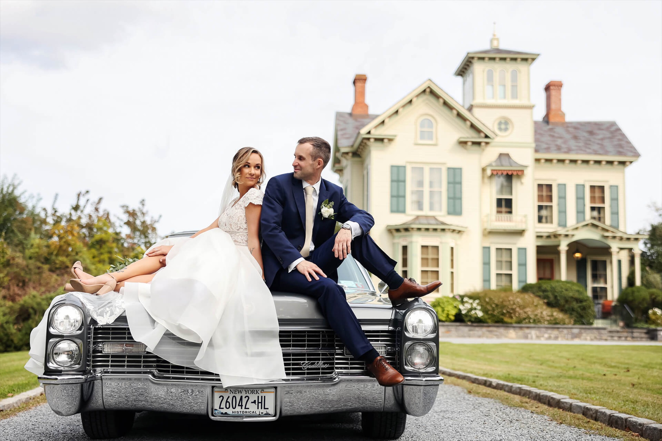 Bride and groom sitting on their truck in front of Jedediah Hawkins Inn - 3 Elements Photography-